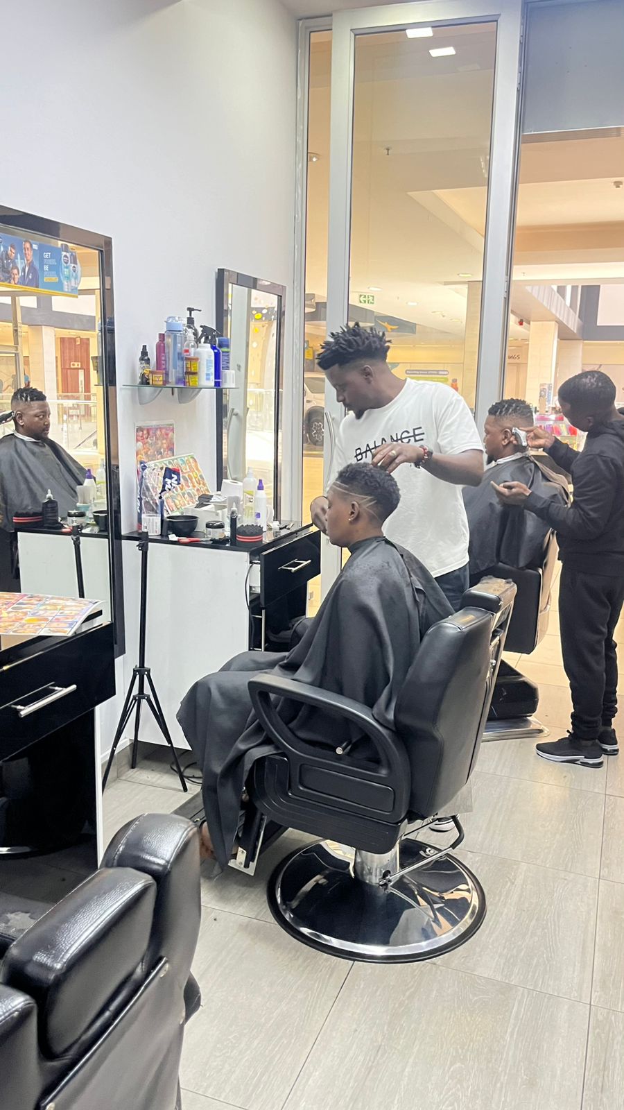 Barber cutting hair in salon